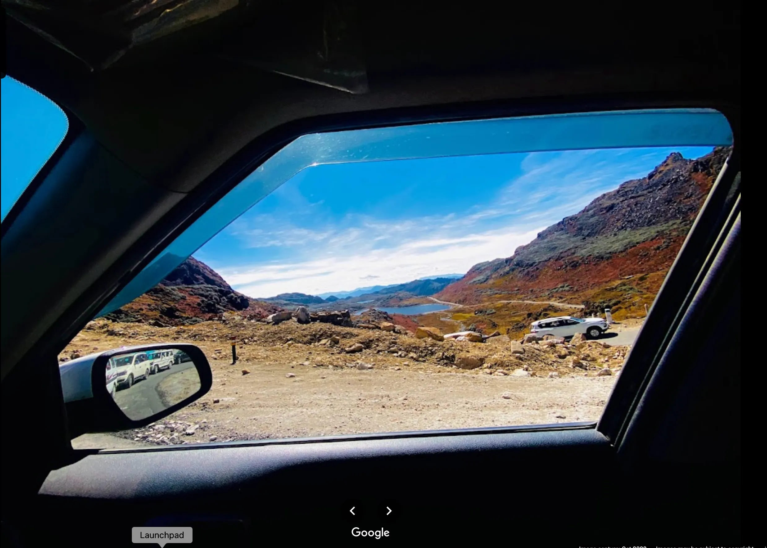 View of the road to Bumla Pass through the window of a car