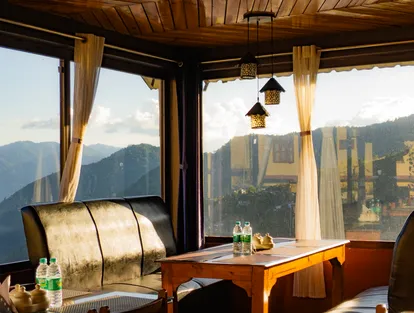 Komu's Kitchen interior with a relaxing sofa overlooking the mountain view of Bomdila